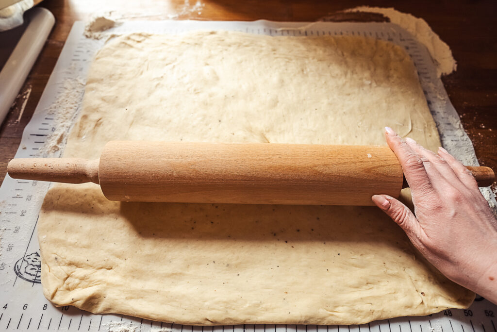 rolling out dough for kanelboller cinnamon rolls