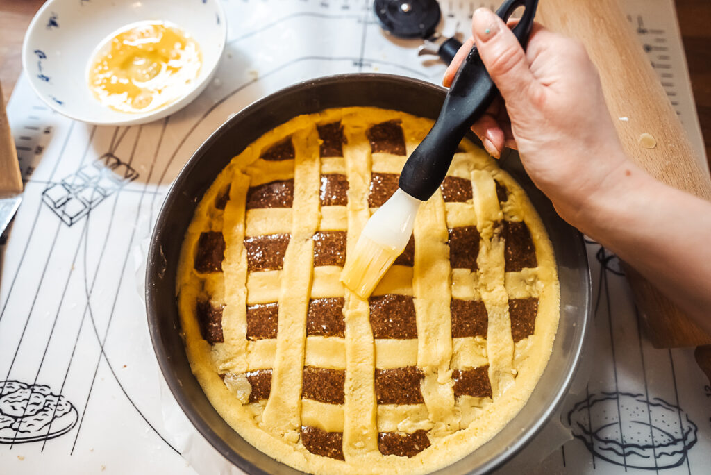 brushing fyrstekake with egg wash