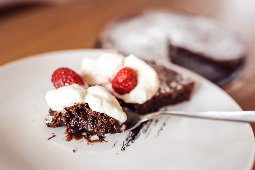 kladdkaka with whipped cream and berries