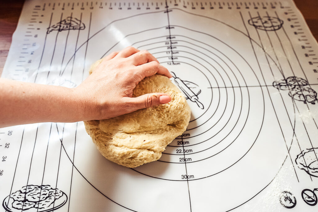 kneading cardamom bun dough