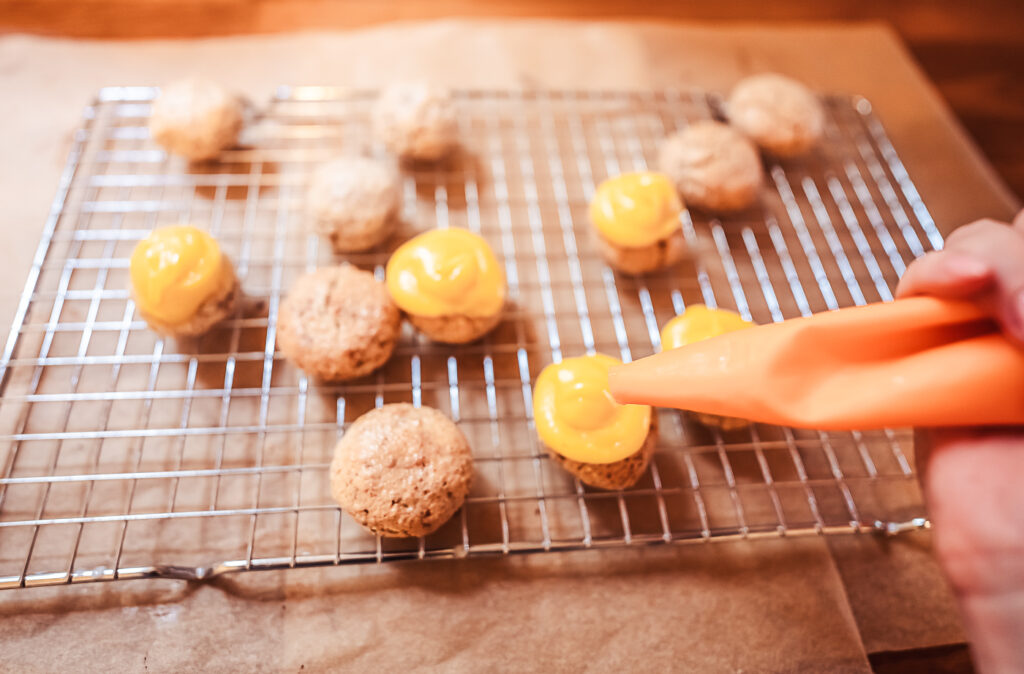 piping egg cream on sarah bernhardt cookies