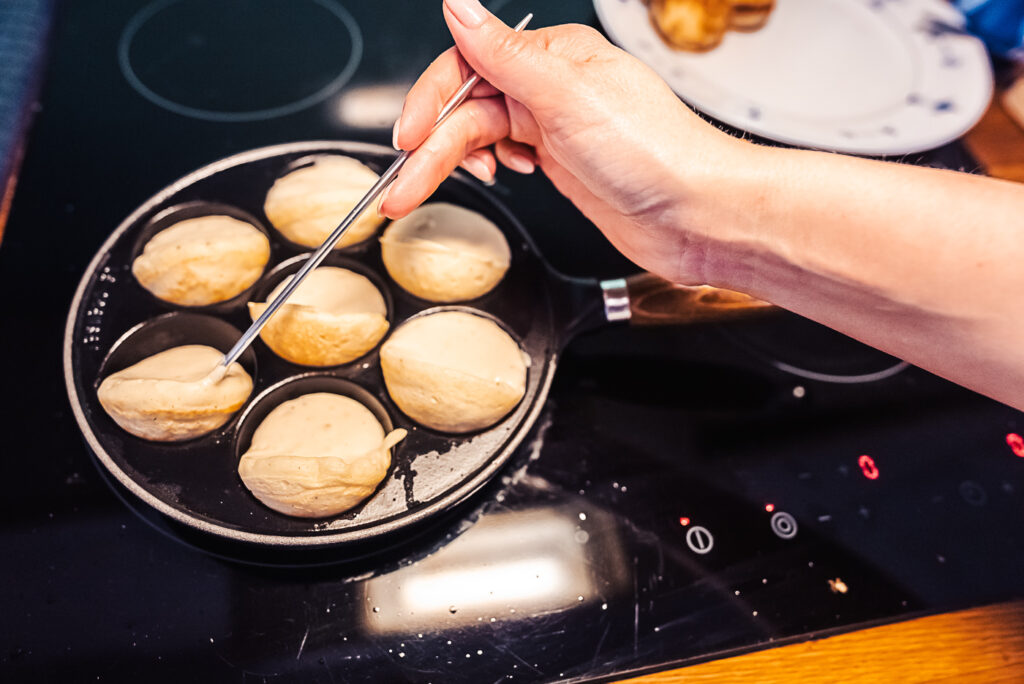 turning aebleskiver in pan