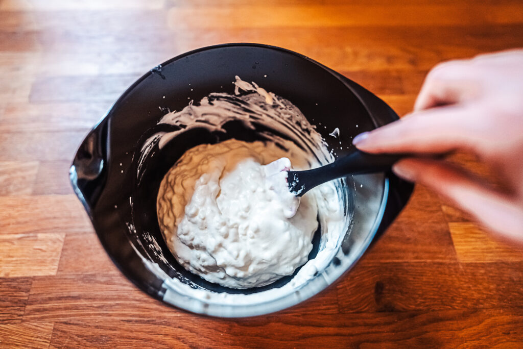 folding whipped cream into rice porridge for riskrem