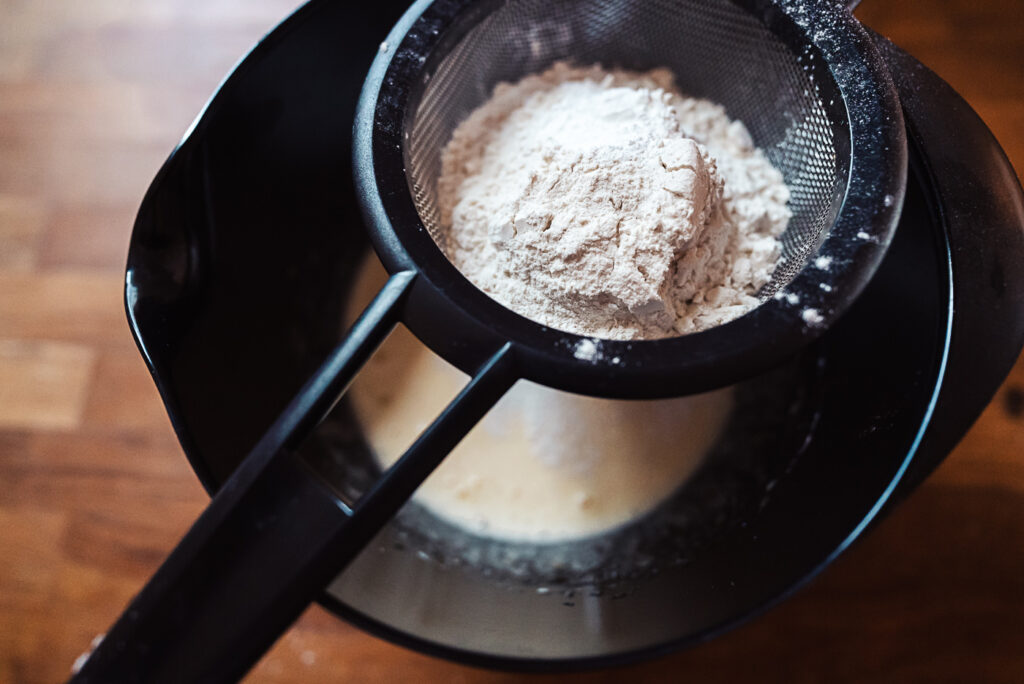 sifting flour into cake batter