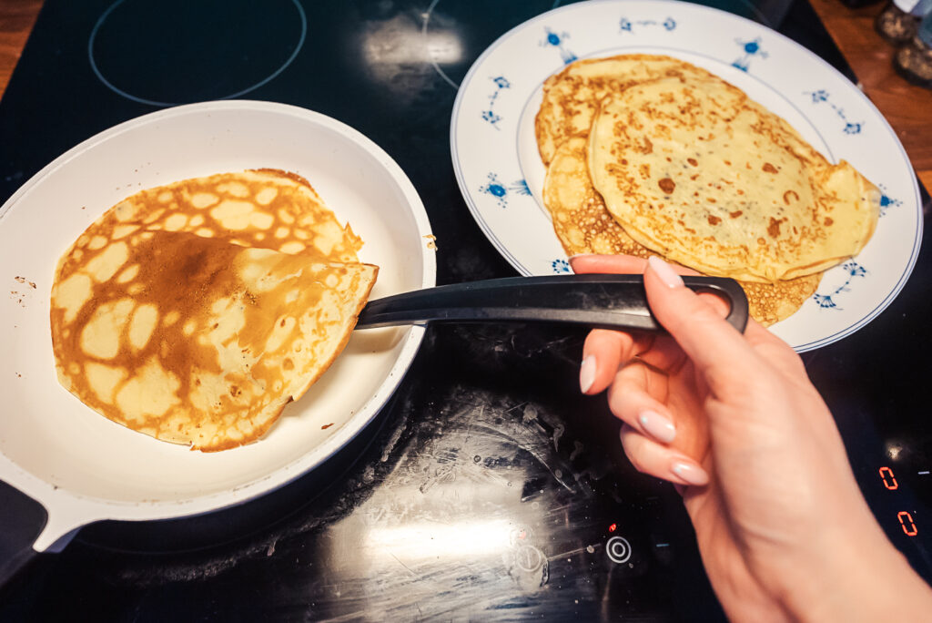 flipping Swedish pancake on skillet
