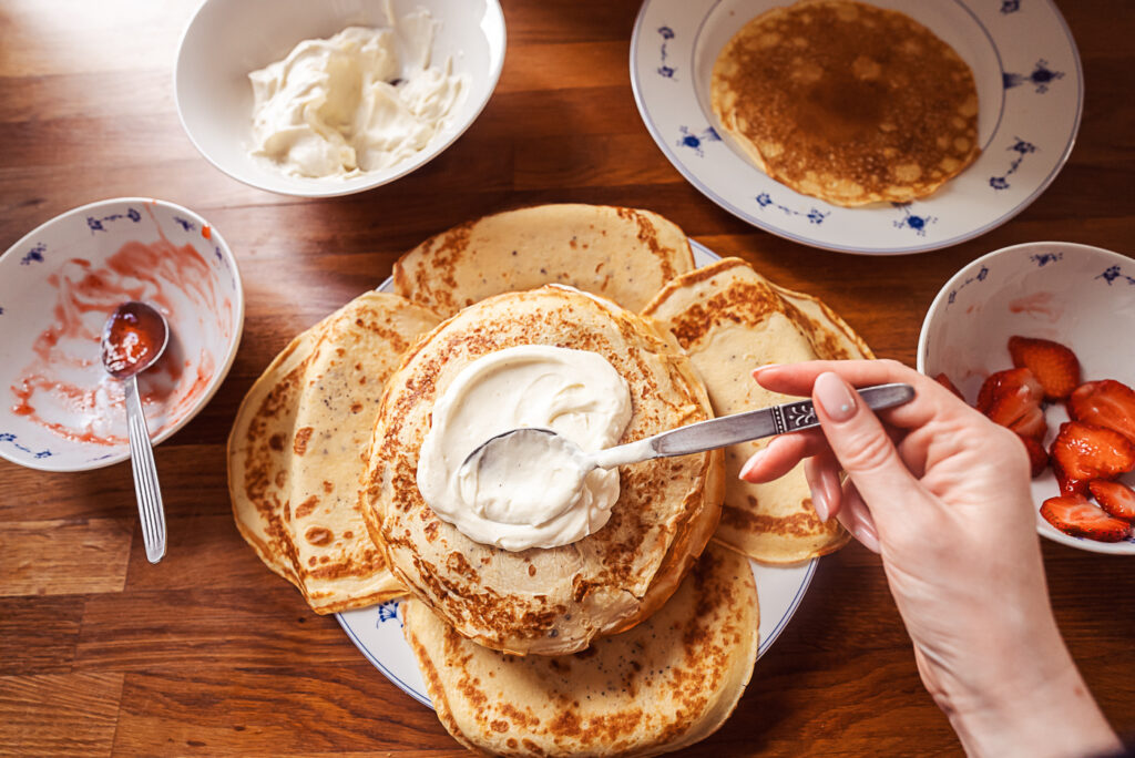 spreading cream on pancake