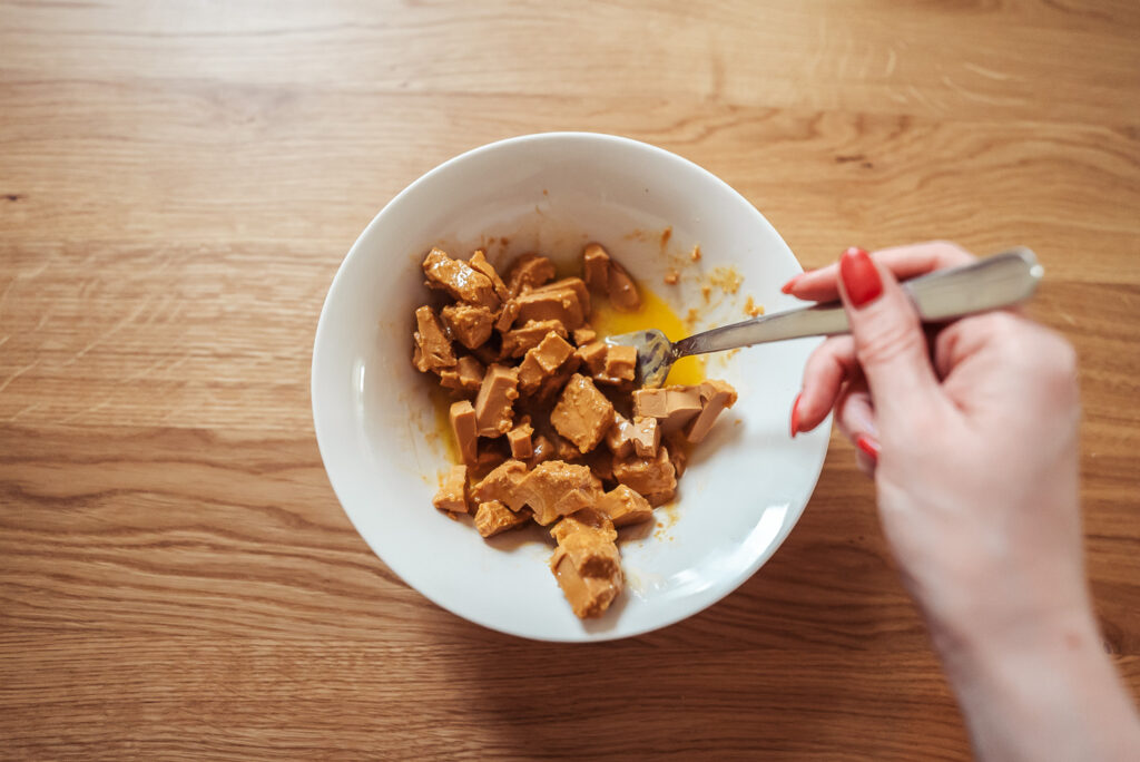 melting brown cheese into butter