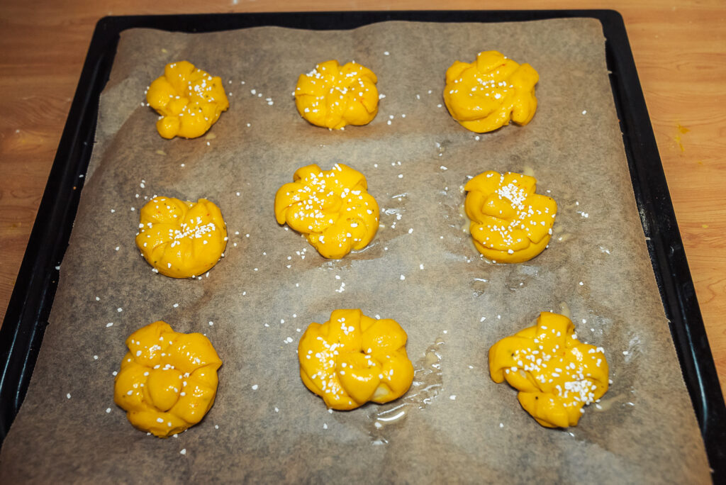 sprinkling saffron buns with pearl sugar