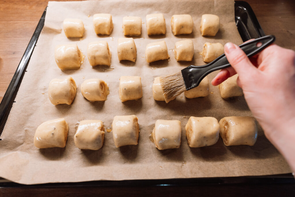 brushing Swedish gifflar with egg wash before baking