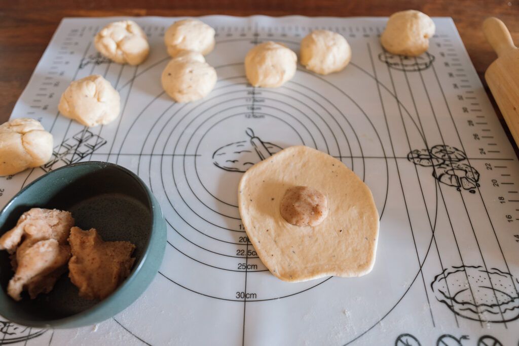 rolling out Norwegian mandelboller (almond buns) dough to add almond filling